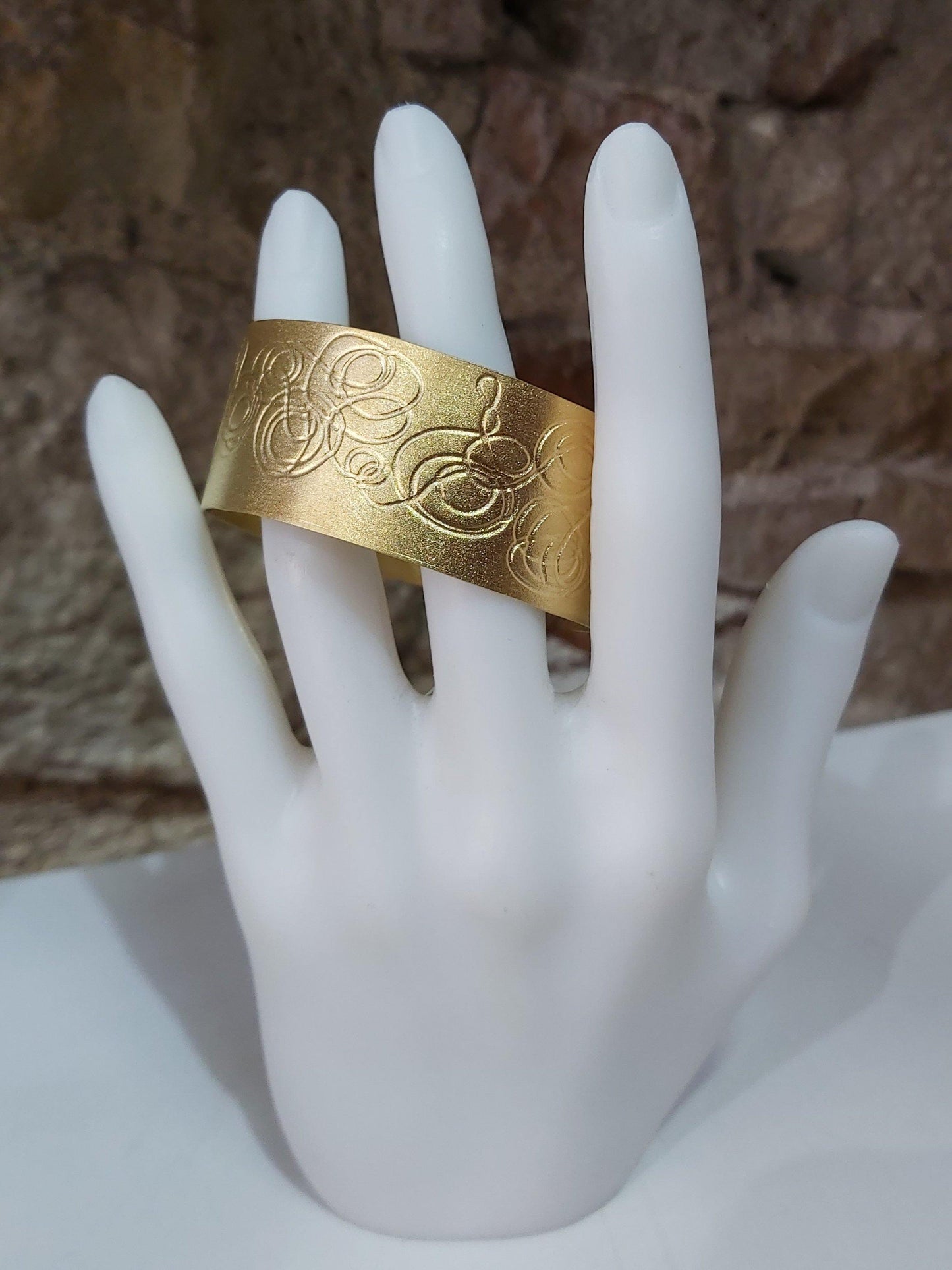 Brazalete exclusivo chapado en oro con grabado original. Hecho a mano por Amparo Valencia. de la colección Trazos . Joyería artesanal en Barcelona